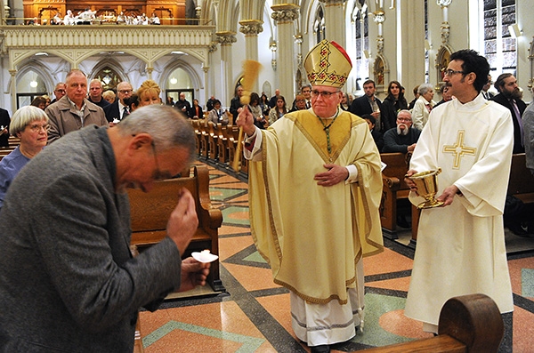 Bishop Richard J. Malone blesses the congregation during the Easter Vigil Mass at St. Joseph Cathedral. (Dan Cappellazzo/Staff Photographer)